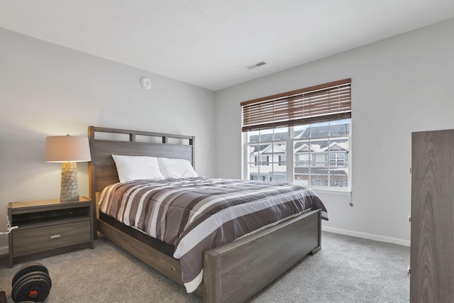 bedroom featuring light colored carpet