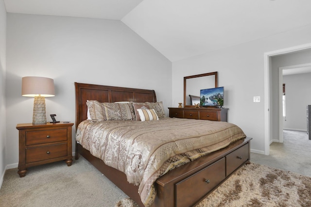 bedroom featuring light carpet and vaulted ceiling