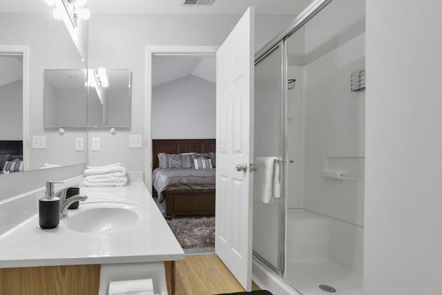 bathroom featuring vanity, an enclosed shower, and lofted ceiling