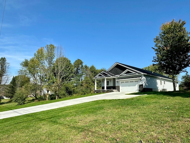 view of front of house with a garage and a front lawn