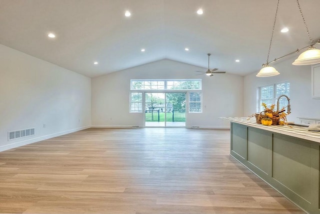 kitchen featuring a wealth of natural light, pendant lighting, and light wood-type flooring