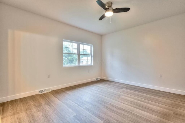 spare room featuring light hardwood / wood-style floors and ceiling fan