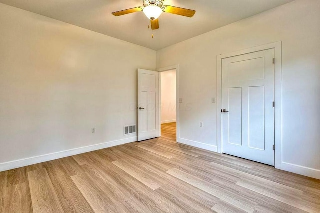 unfurnished bedroom with ceiling fan and light wood-type flooring