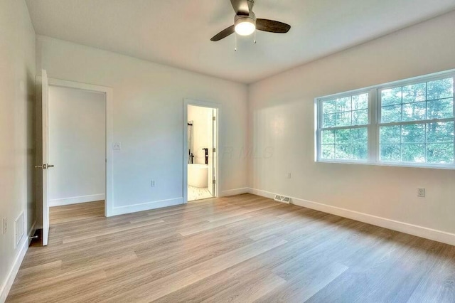 unfurnished bedroom with ceiling fan, light wood-type flooring, and ensuite bathroom