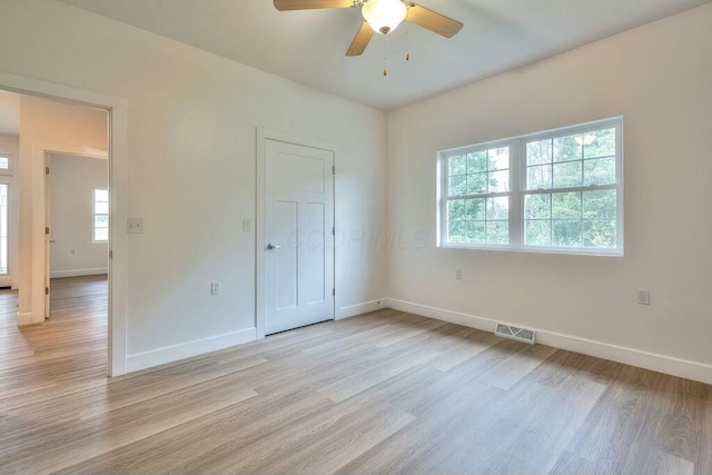 unfurnished bedroom featuring light wood-type flooring, a closet, and ceiling fan