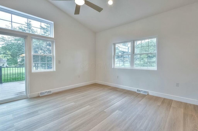 spare room with ceiling fan, light wood-type flooring, and lofted ceiling