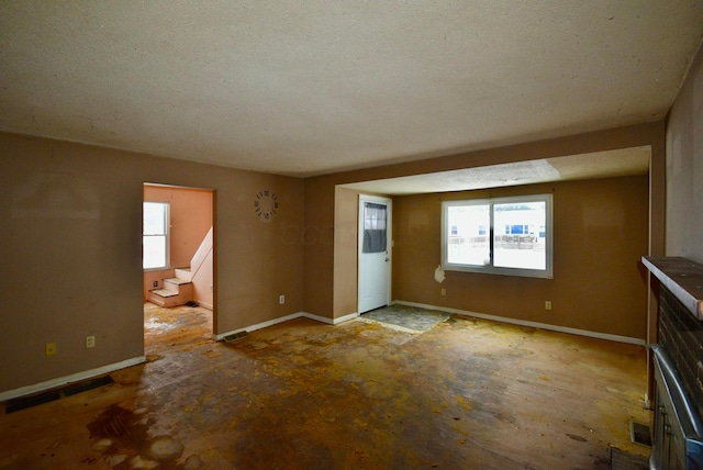 unfurnished living room with a textured ceiling