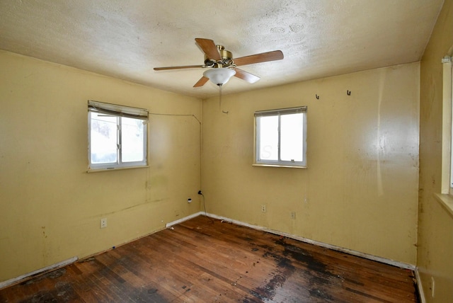 empty room featuring ceiling fan and dark hardwood / wood-style flooring