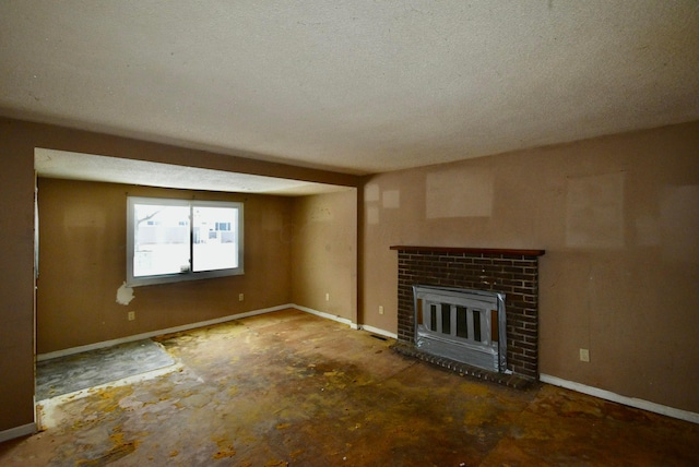 unfurnished living room featuring concrete floors, a textured ceiling, and a brick fireplace