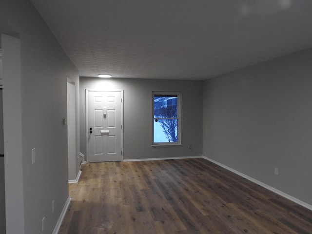 spare room with dark hardwood / wood-style flooring