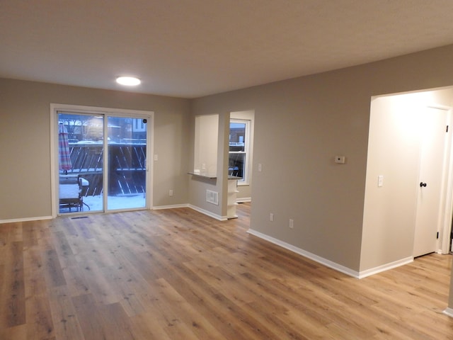 unfurnished living room with light wood-type flooring