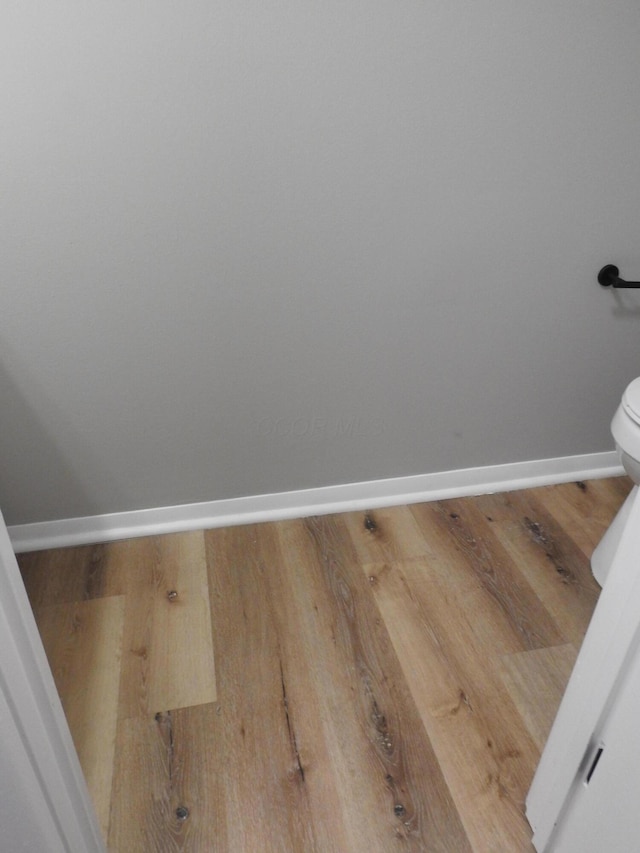 bathroom featuring hardwood / wood-style floors and toilet