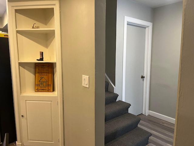 stairs featuring hardwood / wood-style floors