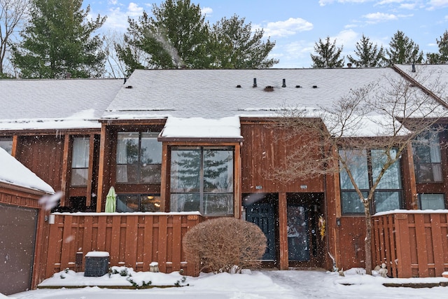 view of snow covered back of property