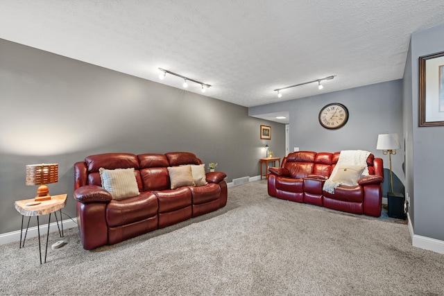 carpeted living room with a textured ceiling and rail lighting