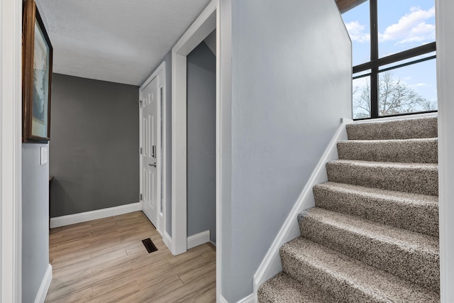 stairs with hardwood / wood-style flooring