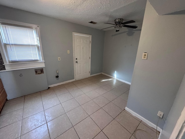 tiled foyer with ceiling fan and a textured ceiling