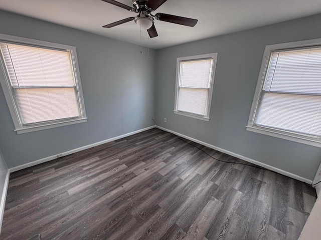 unfurnished room with plenty of natural light, dark wood-type flooring, and ceiling fan