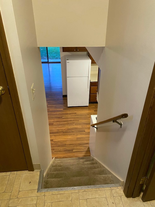 stairway with hardwood / wood-style flooring