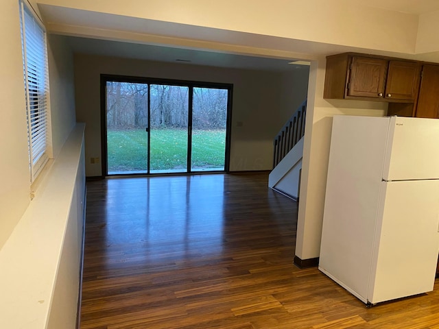 interior space with hardwood / wood-style floors and white fridge