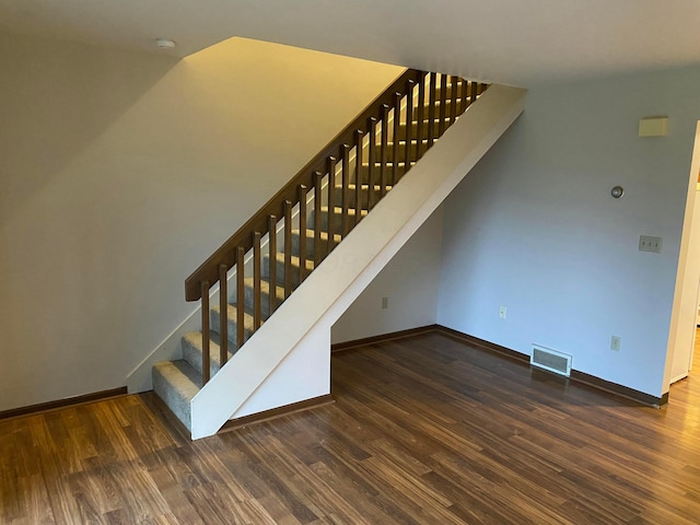 stairs featuring wood-type flooring