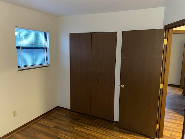 unfurnished bedroom featuring dark hardwood / wood-style flooring