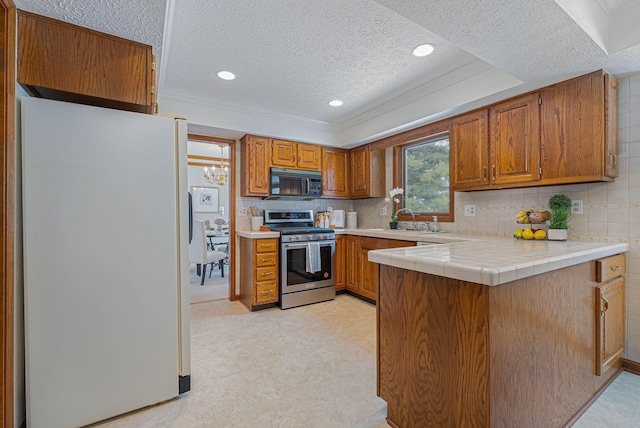 kitchen with electric stove, tile counters, a textured ceiling, and white refrigerator