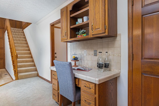 home office with crown molding and a textured ceiling