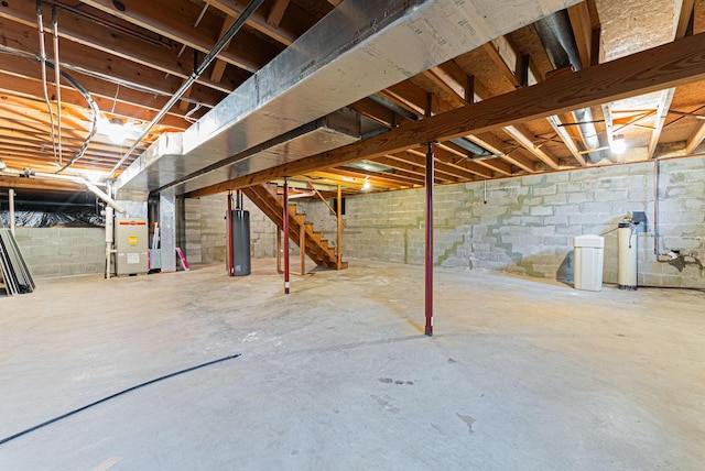 basement featuring heating unit and water heater