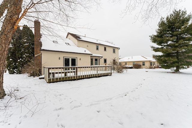 snow covered property featuring a wooden deck