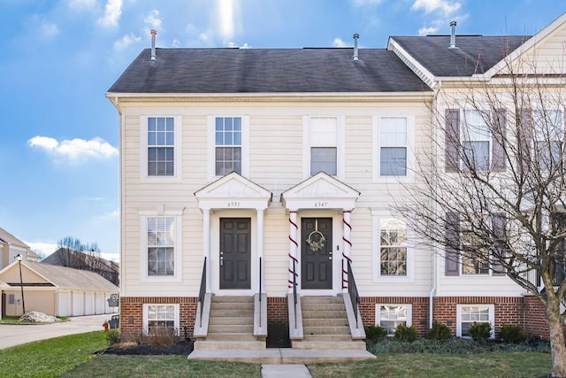 view of property featuring a front lawn