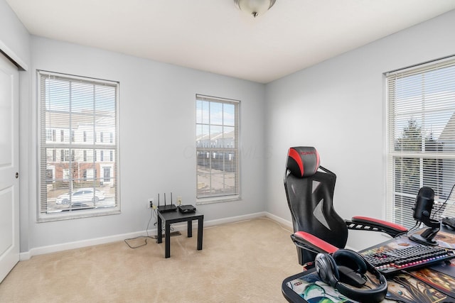 carpeted home office featuring a wealth of natural light