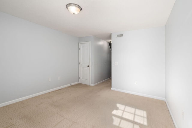 spare room with light colored carpet