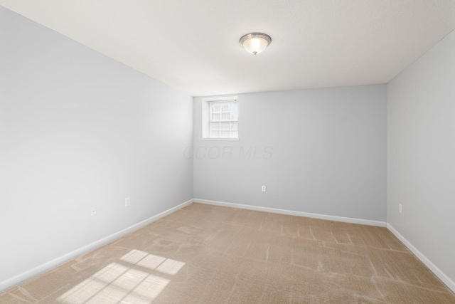 unfurnished room with light carpet