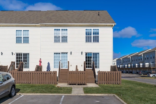 back of property featuring a lawn