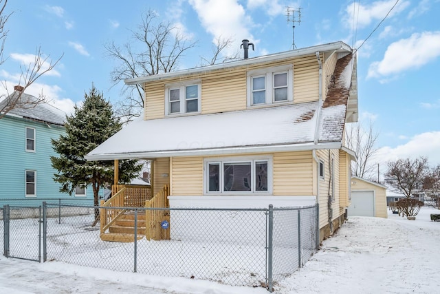 view of property featuring covered porch, a garage, and an outbuilding