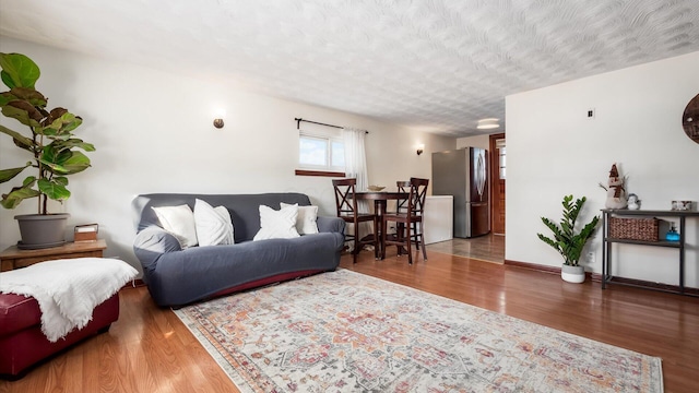 living room featuring a textured ceiling and hardwood / wood-style flooring