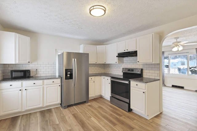 kitchen with white cabinets, ceiling fan, appliances with stainless steel finishes, and light hardwood / wood-style flooring