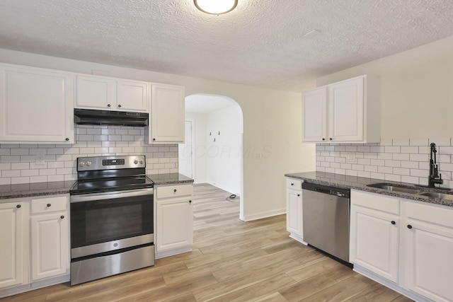 kitchen with sink, white cabinets, stainless steel appliances, and a textured ceiling