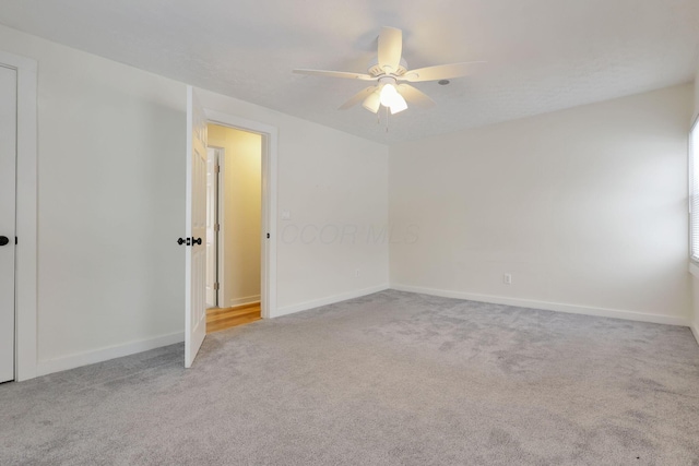 carpeted empty room with ceiling fan