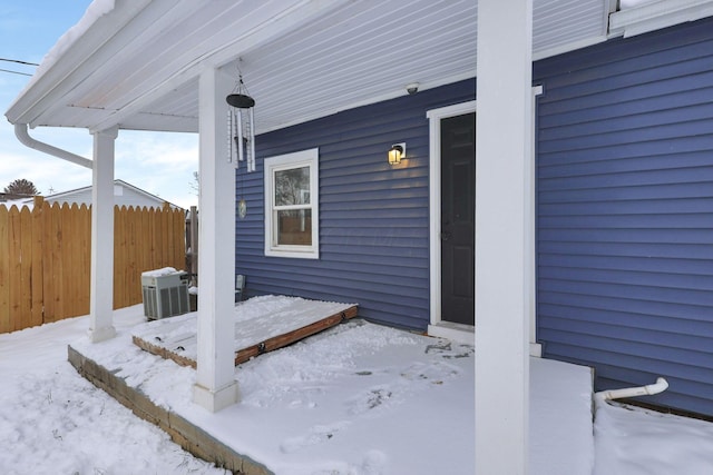 snow covered patio with cooling unit