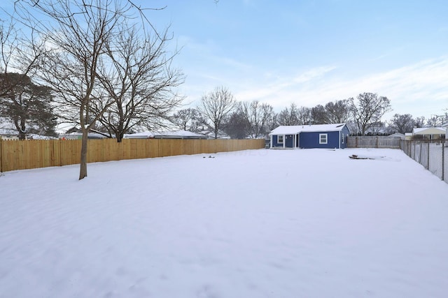 snowy yard with an outdoor structure