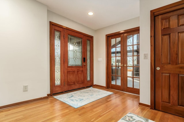 entryway with light hardwood / wood-style floors and french doors