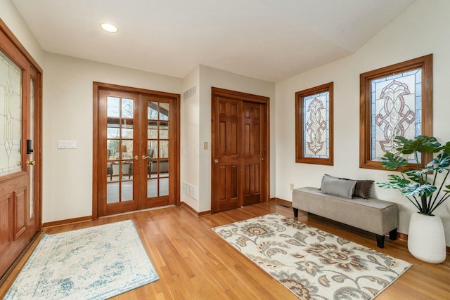 foyer entrance with french doors and light wood-type flooring