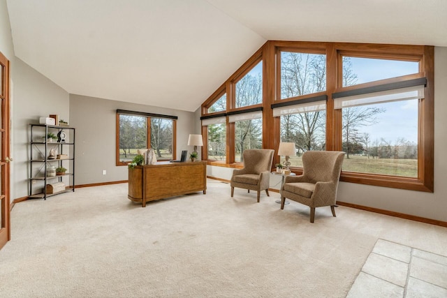 sitting room with light carpet, plenty of natural light, and lofted ceiling