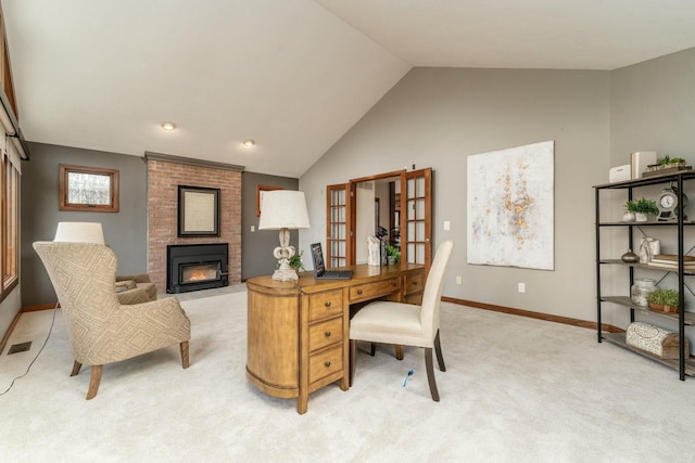 office space featuring light carpet, lofted ceiling, and a brick fireplace