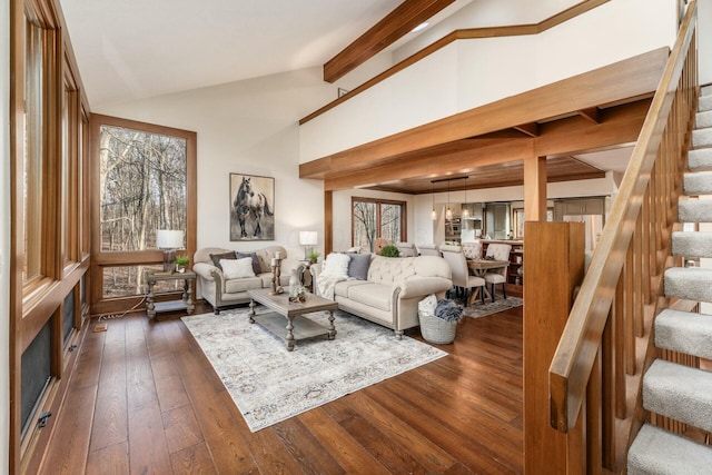 living room featuring vaulted ceiling with beams and dark wood-type flooring