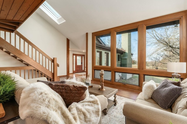 living room featuring light hardwood / wood-style floors and vaulted ceiling