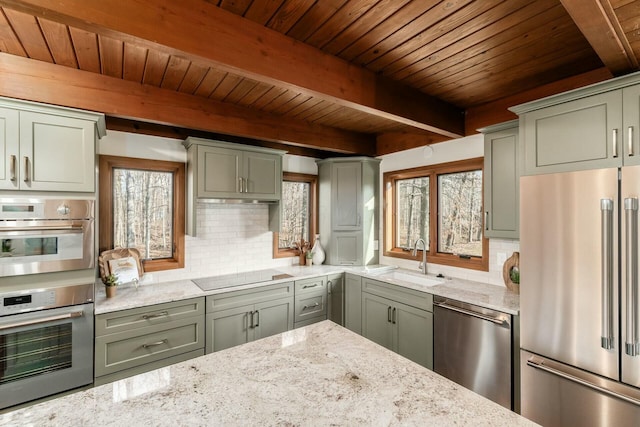 kitchen featuring light stone countertops, sink, beamed ceiling, decorative backsplash, and appliances with stainless steel finishes