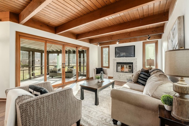 living room featuring french doors, track lighting, hardwood / wood-style flooring, beamed ceiling, and wood ceiling